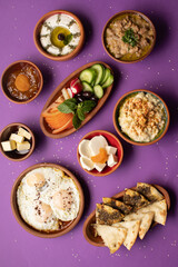 Traditional Lebanese breakfast spread with eggs, mezze, and fresh juice.
