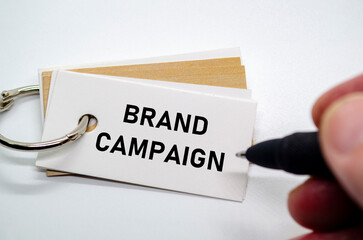 Branding campaign idea illustrated on white paper clipped to a ring with marketing message.