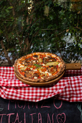 Wood-fired vegetable pizza topped with grilled zucchini, eggplant, and mushrooms.
