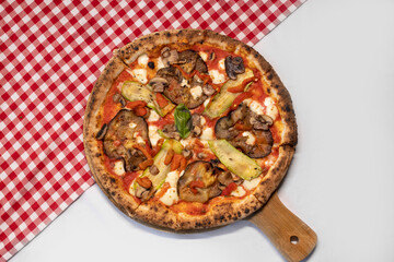 Wood-fired vegetable pizza topped with grilled zucchini, eggplant, and mushrooms.
