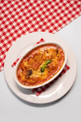 Baked cheesy eggplant parmesan served hot with fresh basil garnish.