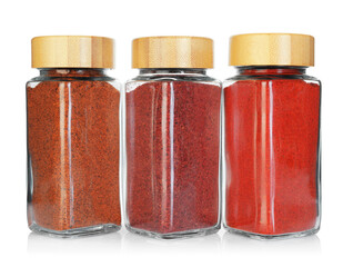 Many different aromatic spices in jars isolated on white