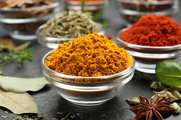 Different aromatic spices on grey table, closeup