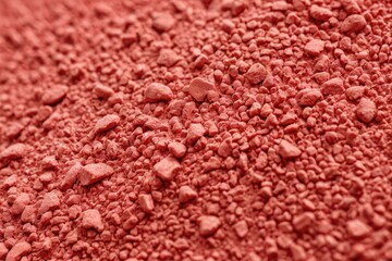 A close-up shot of a pile of reddish brown soil, ideal for use in images about earthy tones or natural landscapes