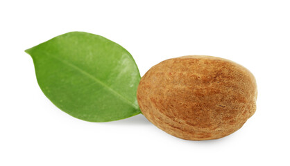 Whole nutmeg and leaf isolated on white