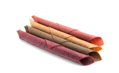 Delicious fruit leather rolls on white background