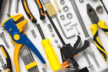 Arrangement of construction tools on white grunge background, closeup