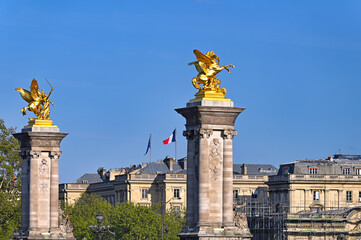 Columns with gilded statues The Alexander III Bridge in Paris, France