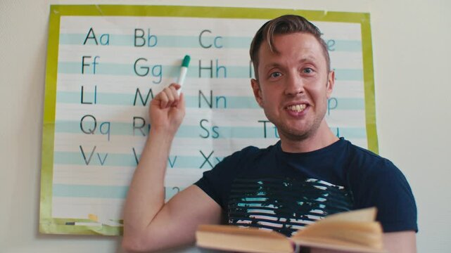 European Caucasian white male man English language teacher tutor teaches English alphabet