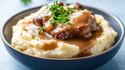 A hearty dish featuring meatloaf smothered in rich gravy, served over fluffy mashed potatoes, exemplifying comfort food at its finest in a rustic kitchen setup.