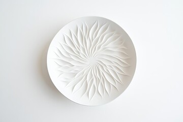 Circular white ceramic plate with intricate, radiating, leaf-like design.  Delicate, embossed patterns create a sunburst effect