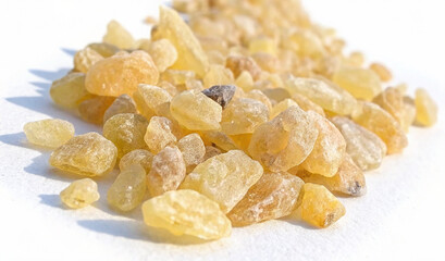 Copal resin stones scattered on white background showcasing natural texture