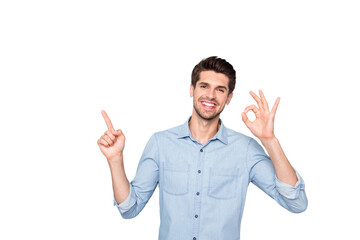 Fototapeta premium Portrait of positive cheerful guy promoter point index finger show ok sign suggest ads advertise promo wear denim jeans outfit isolated over grey color background