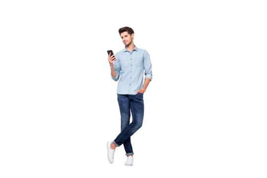 Full size photo of concentrated smm worker man use cellphone answer sms messages have online conversation with friends type comments posts wear stylish outfit sneakers isolated grey color background