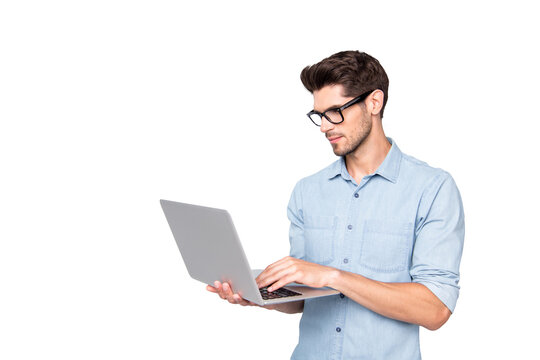Photo of thoughtful focused clever interested freelancer holding laptop with hands wearing eyeglasses working on deadline project isolated grey color background