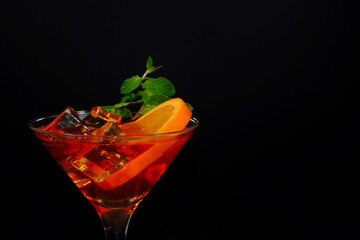 fresh mojito cocktail with lime closeup shot on black background 