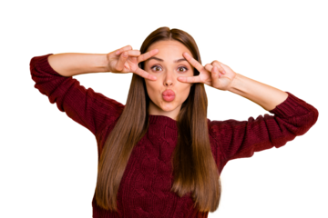 Portrait of  lovely youngster making v-signs sending air kisses wearing burgundy swetaer isolated over yellow background