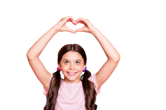 Portrait of cute girls raising hands smiling making heart from fingers looking wearing white t-shirt isolated over pink background - Powered by Adobe