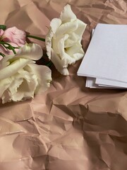 Romantic background with crumpled beige and white papers with copy space for your text. Vintage greeting card