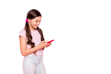 Portrait of cute child holding gadget reading news dressed white t-shirt pants trousers isolated over pink background
