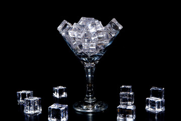 ice cubes on glass with black background closeup view