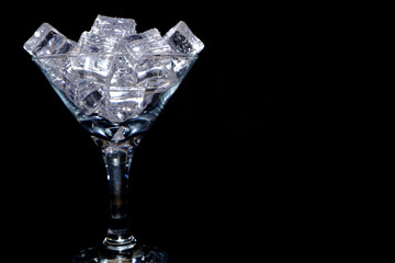 ice cubes on glass with black background closeup view