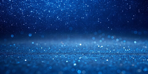 A textured, deep blue background with a sparkling, glittery effect. The surface have a fine, granular appearance that gives it a shimmering, almost metallic or cosmic look. 