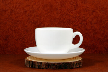 ceramic coffee cup on wooden plate closeup view 