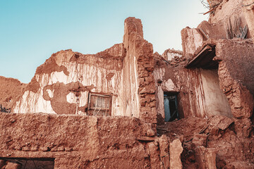 Low angle view of a decaying kasbah in Morocco, highlighting the effects of earthquake and erosion on traditional earthen architecture © EdNurg