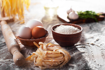 Portion of homemade noodles on floured kitchen table cooking background