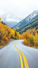 Winding Road Through Autumnal Mountains: A scenic road snakes its way through a majestic mountain landscape, its path embraced by trees ablaze with vibrant autumn hues.