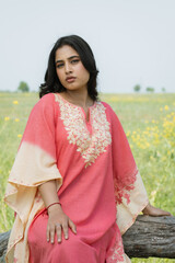 Women posing in pink dress in mustard fields, shoot for kaar kash