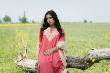Women posing in pink dress in mustard fields, shoot for kaar kash