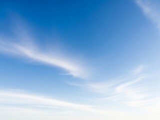 Obraz premium Serene blue sky with wispy cirrus clouds