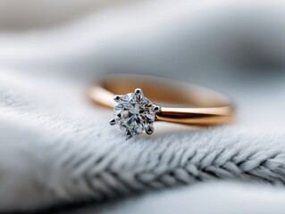 Close-up of Gold Engagement Ring with Diamond Gem on a Knitted Textile