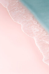 Fototapeta premium Dreamy aerial view captures the gentle embrace of the turquoise ocean onto a blush pink beach