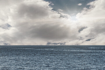 Calm weather on sea or ocean with clouds. Clouds over the ocean.