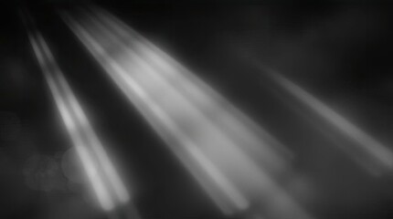 Abstract monochrome image featuring diagonal light rays against a dark background