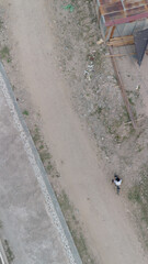 Aerial View of Person Riding Bike on Dirt Road