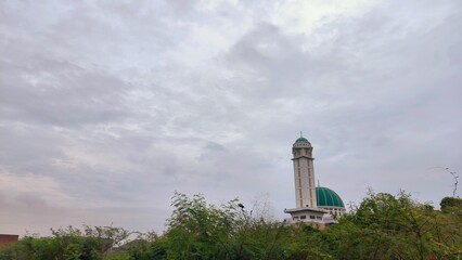Majestic Mosque Minaret and Green Dome Under Cloudy Sky