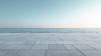 Fototapeta premium serene view of calm ocean meeting clear sky, with smooth concrete surface in foreground