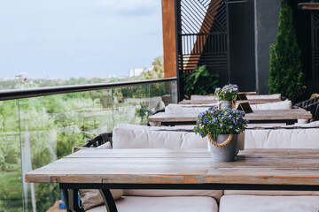 Outdoor Cafe Table With Flowers and City View
