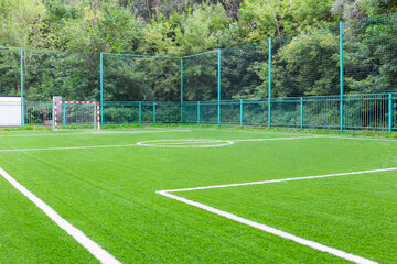 Empty Green Football or Socker Field With White Lines and Goalpost