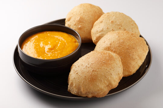 Indian Food - Aamras is a sweet dish made from the pulp of the Alphonso mango fruit. Served with hot puri/poori. Sweet Mango puree garnished with Kashmiri Saffron. Aam Ras Puri OR Alphonso Mango