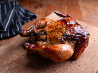 Whole Grilled Chicken on Wooden Table.