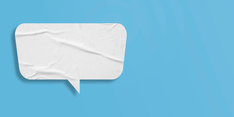 White speech bubble crumpled paper isolated on light blue background