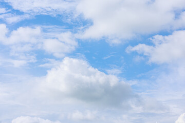 Beautiful cloud formations gather across a vivid blue sky, creating a stunning and peaceful natural backdrop.
