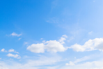 Beautiful cloud formations gather across a vivid blue sky, creating a stunning and peaceful natural...