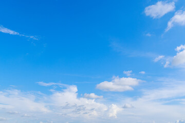 Beautiful cloud formations gather across a vivid blue sky, creating a stunning and peaceful natural backdrop.