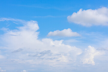 Beautiful cloud formations gather across a vivid blue sky, creating a stunning and peaceful natural backdrop.